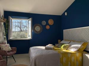 a blue bedroom with a bed and a window at B&B La Vera Vita in Troviggiano +67 photos