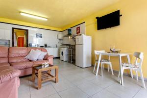 a living room with a couch and a table at Vista Al Mar in Caleta de Interián +14 photos