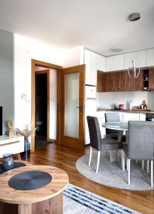 a kitchen and dining room with a table and chairs at Green Harmony Apartment in Pale
