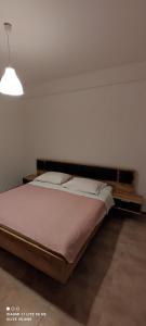 a bed in a room with a white wall at Villa Olive Island in Neviđane