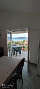 a view of a patio with a table and chairs at Villa Olive Island in Neviđane