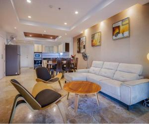 a living room with a white couch and a table at Seaview Condo with Large Pool - BAP1 in Phuket Town