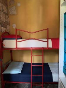 a couple of bunk beds in a room at Cottage Milvia piscina privata rifugio romantico vicino al mare in Tortoreto Lido