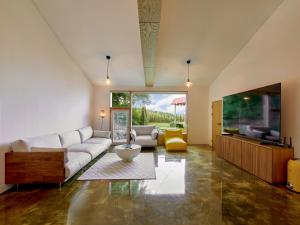 a living room with a couch and a tv at Tokkijib Stay in Gyeongsan