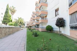 an empty street in front of a apartment building at La Siesta Apt in Salou