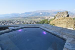 a swimming pool with a view of a mountain at Aqueduct inn in Gjirokastër