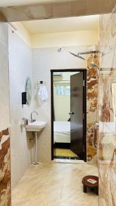 a bathroom with a sink and a shower at Himaksh Homestay in Varanasi +13 photos
