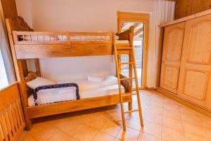 two bunk beds in a room with a ladder at Bergidyll 5 by Alpenidyll Apartments in Ramsau am Dachstein