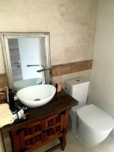 a bathroom with a sink and a toilet and a mirror at Lina Gio Apart in Karlovo +25 photos