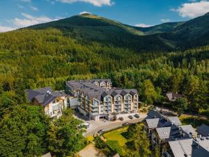 an aerial view of a building with mountains in the background at Green Mountain 5* Hotel in Karpacz
