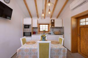 a kitchen with a table with chairs and a dining room at Casa Ponte de Espindo in Lousada