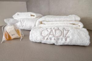 a pile of white towels sitting on a table at VILLA CADIZ APARTMENTS VARAZZE in Varazze +42 photos