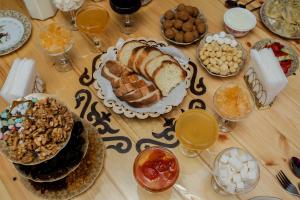 a table topped with different types of food and drinks at AinaGul in Pokrovka +48 photos