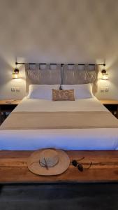 a hat and glasses are sitting on a bed at Relais De Mantadia in Andasibe