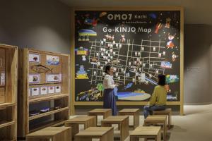 two children looking at a poster in a classroom at OMO7 Kochi by Hoshino Resorts in Kochi