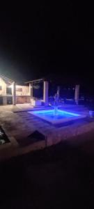 a parking lot with blue lights in a parking garage at Villa Olive Island in Neviđane