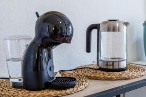 a black mixer sitting on a counter next to a glass at Via del mare angolo via Cavour 2 IUN R1784 in Villasimius