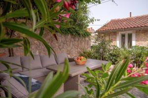 a patio with a table with a basket of fruit at Holiday Home Skala with hot tub & Kala with terrace in Pitve