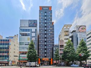 a tall building in the middle of a city at APA Hotel AkihabaraSuehirocho Ekimae -Electric Town- in Tokyo