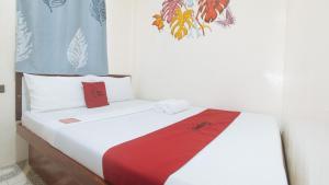 Postel nebo postele na pokoji v ubytování RedDoorz at Queens Hometel
