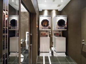 a bathroom with three washing machines in a room at APA Hotel AkihabaraSuehirocho Ekimae -Electric Town- in Tokyo