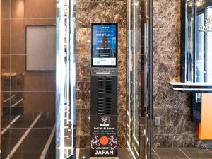 a remote control on the wall of a building at APA Hotel AkihabaraSuehirocho Ekimae -Electric Town- in Tokyo