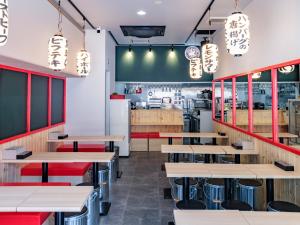 a restaurant with wooden tables and benches at APA Hotel AkihabaraSuehirocho Ekimae -Electric Town- in Tokyo