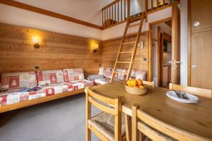 a dining room with a table and bunk beds at Résidence Le Golf in Méribel +40 photos