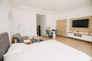a bedroom with a bed and a tv on a wall at KS Apartments in Visoko