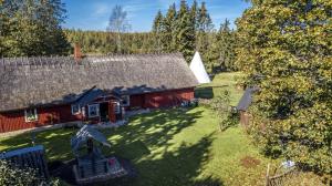 an aerial view of a red barn with a yard at Kargoja Talu in Saunametsa