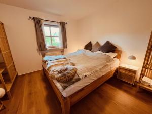 a bedroom with a large bed in a room at Achentalglück in Unterwössen