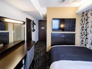 a hotel room with a bed and a desk at APA Hotel AkihabaraSuehirocho Ekimae -Electric Town- in Tokyo