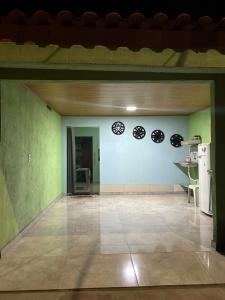 a room with green walls and a kitchen with plates on the wall at Quarto privativo,não é compartilhado! in Parauapebas
