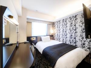a hotel room with a bed and a desk at APA Hotel AkihabaraSuehirocho Ekimae -Electric Town- in Tokyo