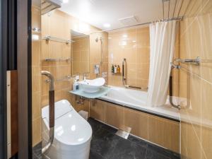 a bathroom with a toilet and a sink and a shower at APA Hotel AkihabaraSuehirocho Ekimae -Electric Town- in Tokyo