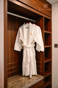 a white robe is hanging in a closet at Ocean Senses Hotel in Ðông Thôn +37 photos