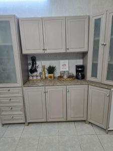 a kitchen with white cabinets and a counter top at شقة مميزة غرفتين وصالة جيزان عوائل - وصول ذاتي in Jazan +7 photos