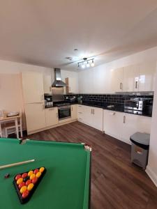 a kitchen with a pool table in a room at Spacious Leicester Apt with Free Parking, Sleeps 6 in Leicester
