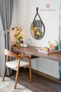a desk with a chair and a mirror at Ocean Senses Hotel in Ðông Thôn