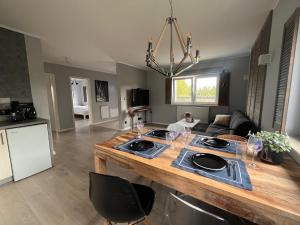 a kitchen and living room with a large island at CHILLIapartamenty - Dom w Grzybowie-W Brzozach in Grzybowo +6 photos