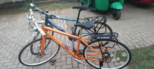 an orange bike is parked on a sidewalk at Pick & Go White House in Negombo