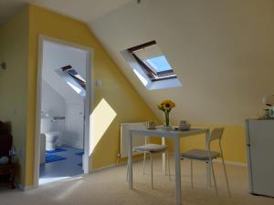 a dining room with a table and a skylight at The Old Cornstore a beautiful Suite overlooking the sea in Drummore