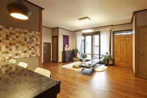 a large living room with a table and chairs at Jiwoljang Guesthouse in Seoul