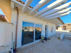 a pergola on a house with a patio at La nuvola in Fiumicino