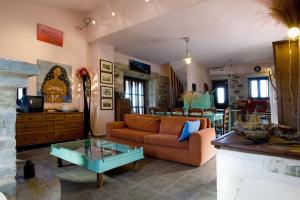 a living room with a couch and a glass table at Benos Tower in Tsikkaliá