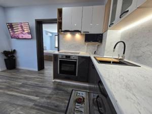 a kitchen with a sink and a stove at Модерен апартамент в Гр Елена in Elena +6 photos