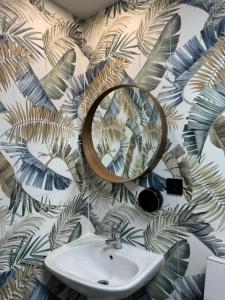 a bathroom with a sink and a mirror on a wall at The POD Suite Hostel Village in Valencia +91 photos