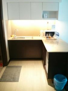a kitchen with a sink and a counter top at Adha Studio & Suite Kota Bharu in Kota Bharu