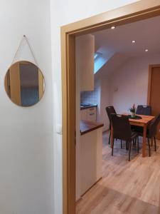a kitchen and dining room with a table and chairs at Ferienwohnung Bohinj in Bohinjska Bistrica +10 photos