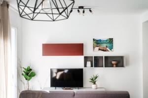a living room with a tv and a couch at Lario Suite Apartments by Quokka 360 - Close to Como Downtown in Como
